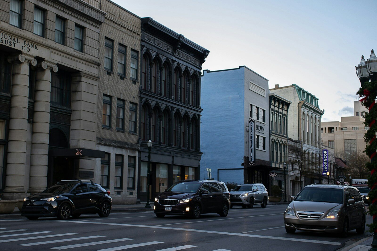 cars parked on side of the road near building during daytime. lexington