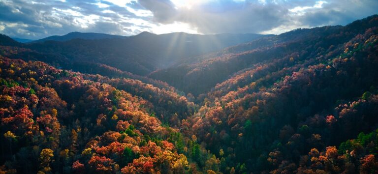 the sun shines through the clouds over the mountains. roadtrips from nashville
