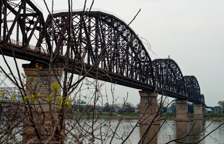 a train bridge over a body of water. louisville adventures